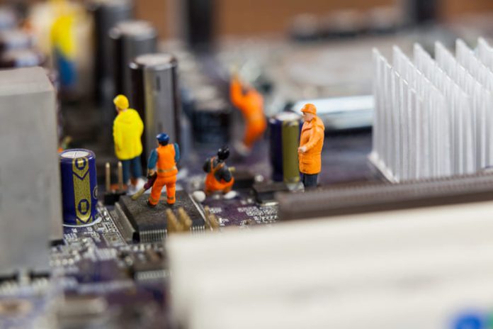 miniature-workers-working-chip-motherboard (1) (1) Why Hardware Lifecycle Management Now Shapes Long-Term Competitiveness