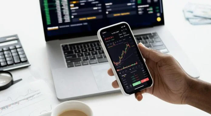 Top 10 MT5 Tips and Tricks Every Trader Should Know (2025 Edition) Person holding a Smartphone for MT5 trading