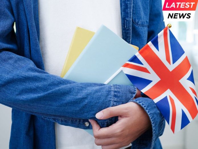 UK Rejoins - student holding book with flag