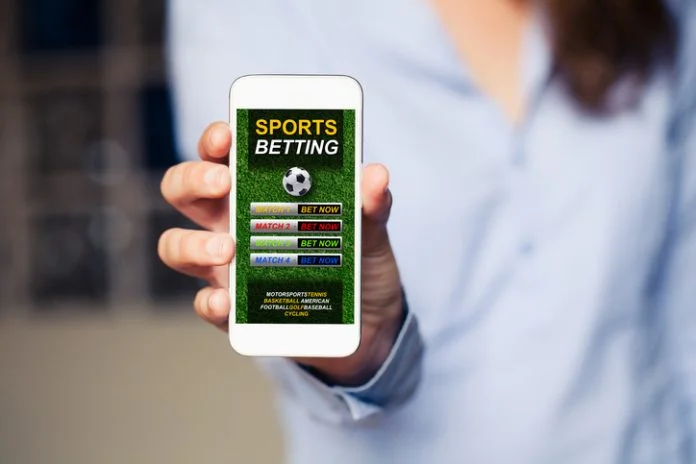 Mobile phone with sports betting website app in the screen. Sports betting in Irish startup