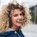 Beginner-Friendly Curls: Isee Hair Curly Wig vs. Glueless Curly Wig Options Portrait of a young woman with curly hair
