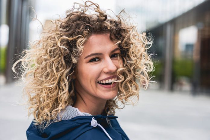 Portrait of a young woman with curly hair