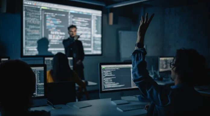 The Creativity Quotient: Can Business Schools Really Teach What AI Will Never Learn? Teacher Giving Computer Science Lecture to Diverse Multiethnic Group in Business Schools