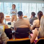 Corporate - business woman holding presentation