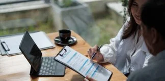 Female health insurance broker presenting his insurance benefits to businessman fill out insurance policy. Digital Transformation in Insurance