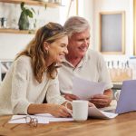 An older couple considers estate planning decisions that they intend to make in their wills.