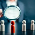 How Leaders Can Own Their Potential — And Stop Holding Back Magnifying success powerful red wooden businessman leading way. Identiying leader with potential concept