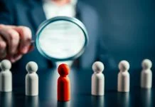 How Leaders Can Own Their Potential — And Stop Holding Back Magnifying success powerful red wooden businessman leading way. Identiying leader with potential concept