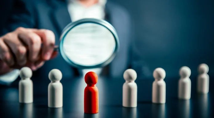 How Leaders Can Own Their Potential — And Stop Holding Back Magnifying success powerful red wooden businessman leading way. Identiying leader with potential concept