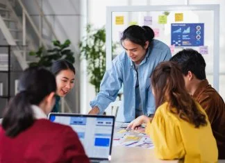 Why Long-Term Partnerships With UX Agencies Work Better Than One-Off Projects Asian ux developer agency and ui designer brainstorming about mobile app interface wireframe design on meeting table with at modern office.