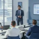 Office Conference Room Meeting: Digital Enterpreneur Presents e-Commerce Investment Strategy for Group of Investors. Boardroom Strategies for Dominating AI Investments, Risks, and Value