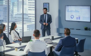 Office Conference Room Meeting: Digital Enterpreneur Presents e-Commerce Investment Strategy for Group of Investors. Boardroom Strategies for Dominating AI Investments, Risks, and Value