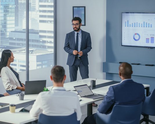 Office Conference Room Meeting: Digital Enterpreneur Presents e-Commerce Investment Strategy for Group of Investors. Boardroom Strategies for Dominating AI Investments, Risks, and Value