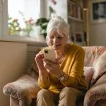 Old lady enjoying dating app using Meetheage