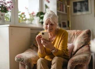 Old lady enjoying dating app using Meetheage