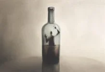 Addiction Has No Boundaries: We Must Start Talking About It Illustration of man imprisoned in a bottle of alcohol, surreal addiction abstract