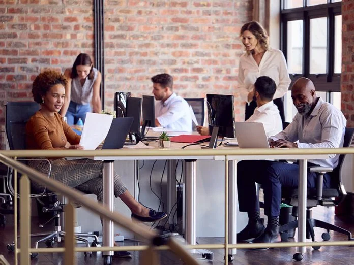 Business Team Working Together In Busy Multi-Cultural Office Leading Through the Fear of DEI: A Guide for European Business Leaders