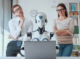 business people supervising an AI robot working in the office. Person with emotional intelligence and AI