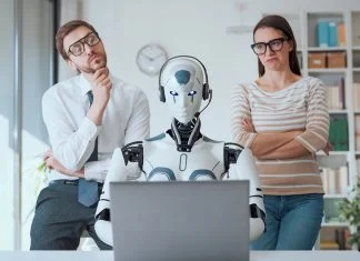 Emotional Intelligence is Key to Adopting Artificial Intelligence business people supervising an AI robot working in the office. Person with emotional intelligence and AI