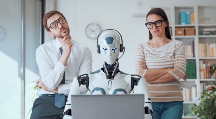 business people supervising an AI robot working in the office. Person with emotional intelligence and AI