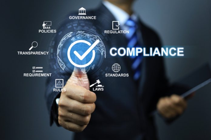 Compliance concept Compliance concept with businessman thumb up checkmark to applied standard and regulation for export products to foreign countries to meet government trade requirement in global business