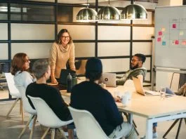 They work together as a team, brainstorming creative ideas for a successful tech company project. Guided by a confident leader, their collaboration fosters a professional and innovative workplace environment. Storytelling for Talent Retention concept.
