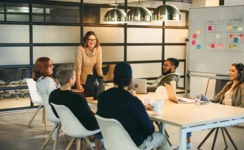 They work together as a team, brainstorming creative ideas for a successful tech company project. Guided by a confident leader, their collaboration fosters a professional and innovative workplace environment. Storytelling for Talent Retention concept.