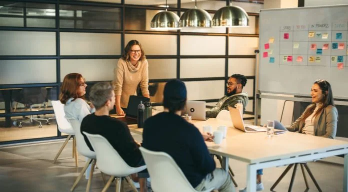 They work together as a team, brainstorming creative ideas for a successful tech company project. Guided by a confident leader, their collaboration fosters a professional and innovative workplace environment. Storytelling for Talent Retention concept.