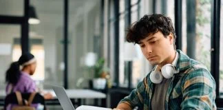 Student writing while utilizing Assignment Writing Services