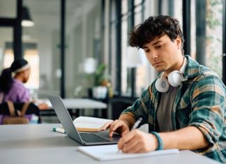 Student writing while utilizing Assignment Writing Services
