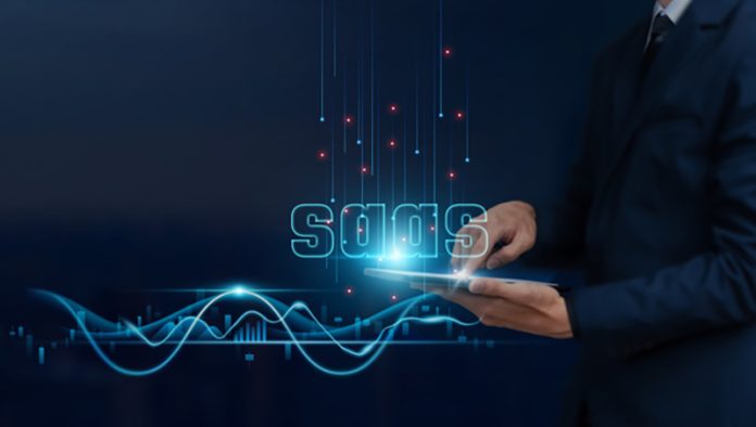 SaaS: Software as a Service Concept, Businessman Uses Tablet on SaaS Global Networking, Collaborating, Analyzing Data, Innovating, Developing Smart Solutions from Digital Technology. SaaS Growth Plateaus Even When the Product Is Strong