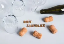 Dry January is Popular, But Approach With Caution, Says Expert Overturned glasses, empty bottles, corks and text dry january on gray background