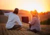 Backing Europe’s Farmers is Key to Scaling Climate-Smart Agriculture Farmers using laptop for smart farming analysis while observing rural field during sunset. Concept of modern agriculture and farm innovation