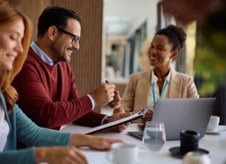 Understanding the Fiduciary Standard: What Scottsdale Residents Should Know Happy couple coming to and agreement with their financial advisor. Focus is on man signing a contract following the Fiduciary Standard