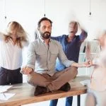 Elevating corporate culture - sitting on table and meditating