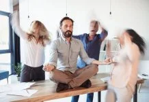 Elevating corporate culture - sitting on table and meditating
