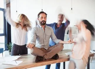 Elevating Corporate Culture With Stress-Relief and Energy Techniques Elevating corporate culture - sitting on table and meditating