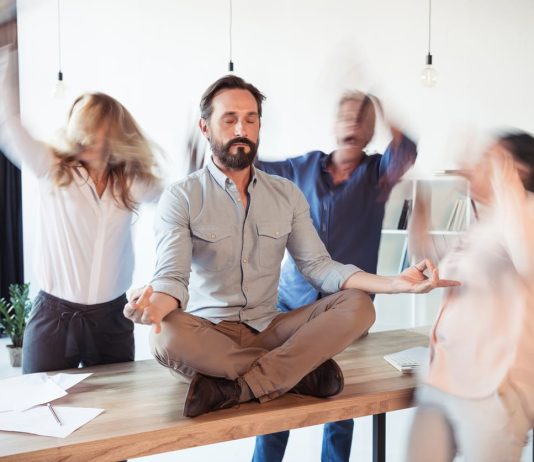 Elevating corporate culture - sitting on table and meditating