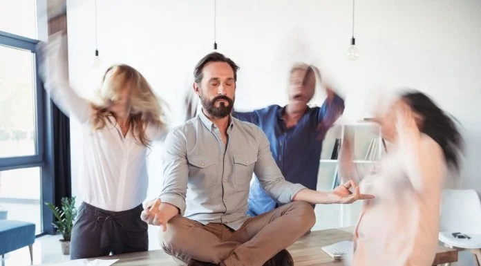 Elevating Corporate Culture With Stress-Relief and Energy Techniques Elevating corporate culture - sitting on table and meditating