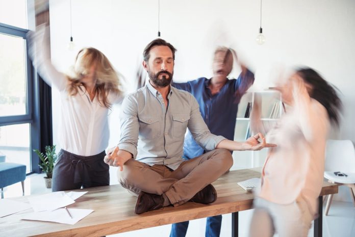 Elevating corporate culture - sitting on table and meditating