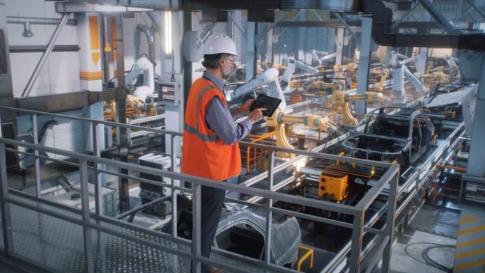 iStock-1385910387 (1) (1) Manufacturing Plants - worker controlling production line