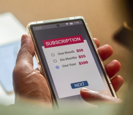 Consumer Behaviour in the Digital Age. Man choosing a subscription plan for one year using mobile applications