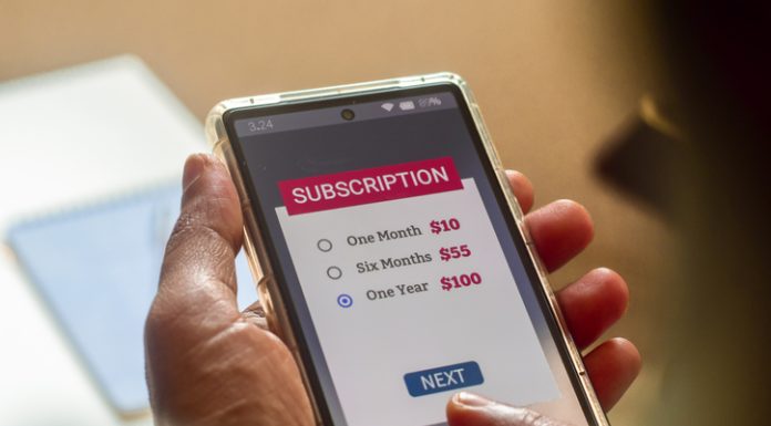 Consumer Behaviour in the Digital Age. Man choosing a subscription plan for one year using mobile applications