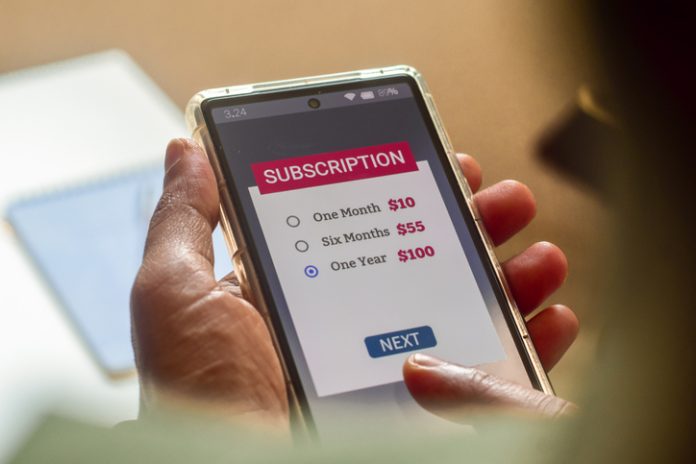 Consumer Behaviour in the Digital Age. Man choosing a subscription plan for one year using mobile applications