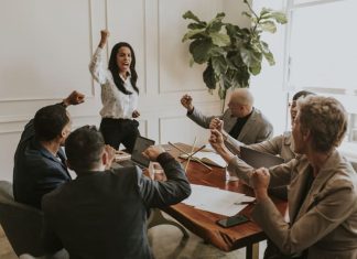 Businesswoman motivating her team members and leading the team with confidence