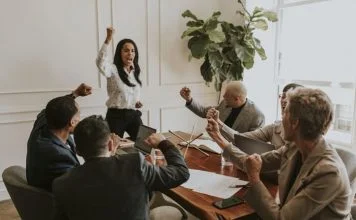 Businesswoman motivating her team members and leading the team with confidence