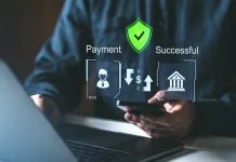 How Secure Payment Processing Protects Your Business and Customers A person using a smartphone and laptop with holographic payment icons, secure shield, and success symbols. Concept of secure online payment