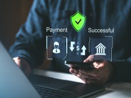 A person using a smartphone and laptop with holographic payment icons, secure shield, and success symbols. Concept of secure online payment