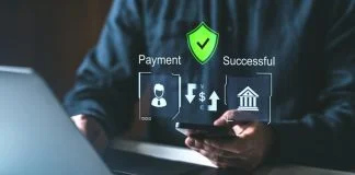 A person using a smartphone and laptop with holographic payment icons, secure shield, and success symbols. Concept of secure online payment