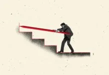Businessman pushing giant red pencil up staircase symbol of challenge strategy and persistence in career.